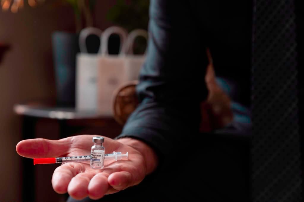 A GLP-1 dose held in hand